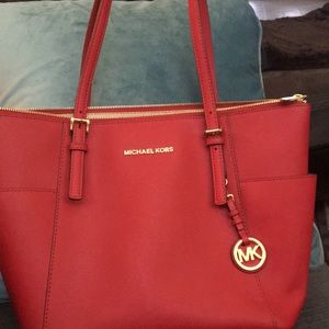Michael Kors red purse with gold trim